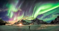 A-person-standing-at-night-looking-up-at-the-Northern-Lights.jpg